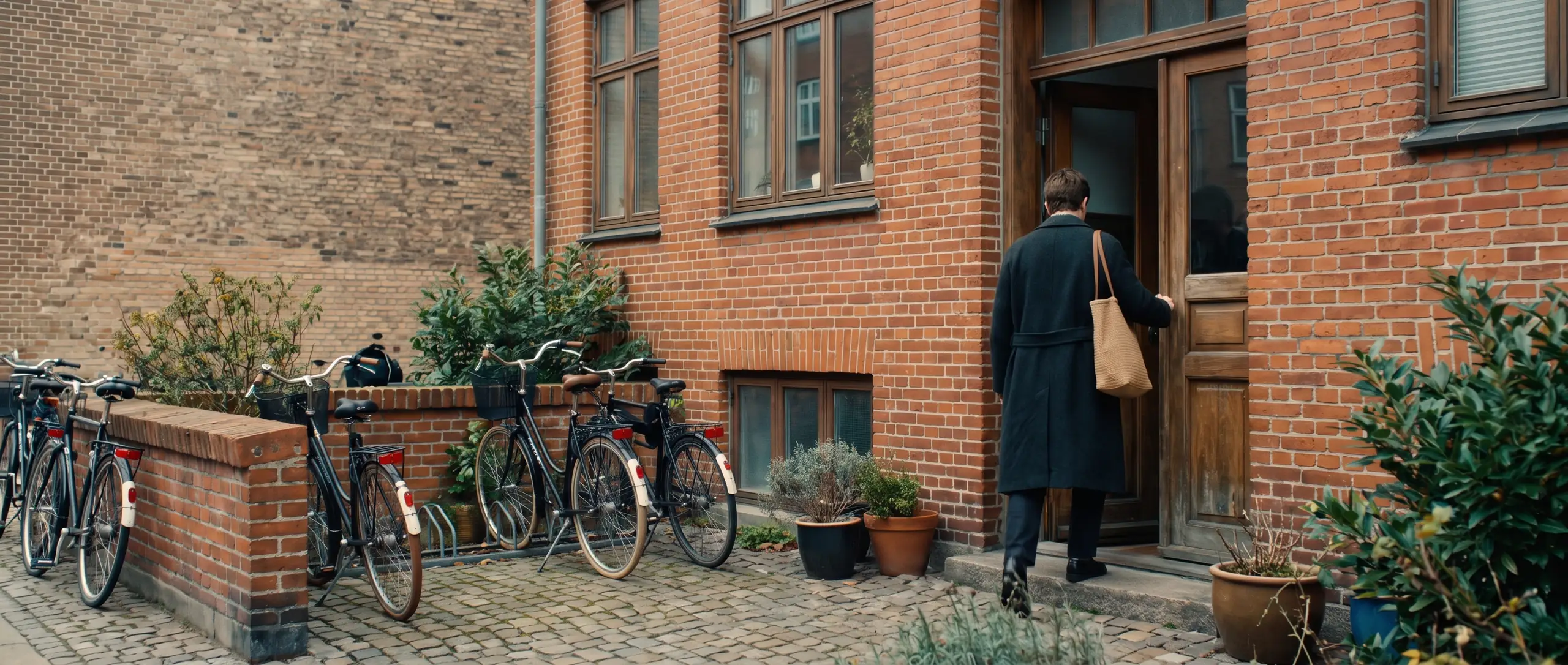 The entrance of a red-brick apartment block